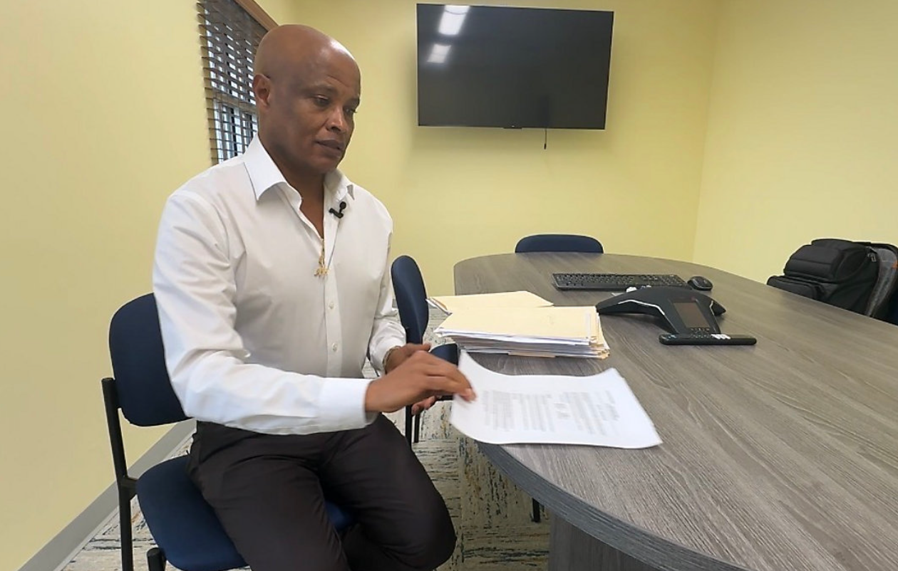 Abinet Belachew, Daytona Beach's city auditor, reviewing documents at a conference table
