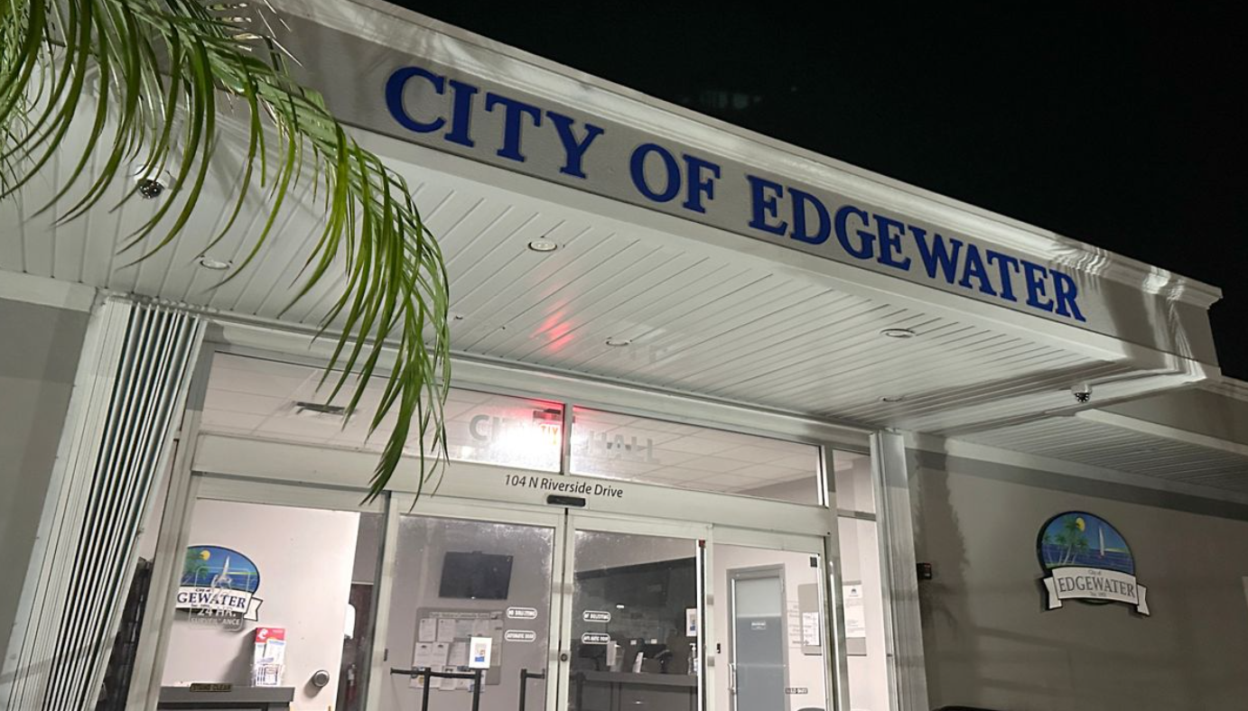 Entrance to Edgewater City Hall at night with the City of Edgewater sign